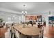 Open concept dining room features a large wooden table and hardwood floors at 1724 Bee Balm Rd, Johns Island, SC 29455