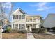 Two-story house with front porch, landscaping, and a walkway at 1724 Bee Balm Rd, Johns Island, SC 29455