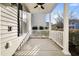 Covered porch with white railing and ceiling fan, ideal for relaxing at 1724 Bee Balm Rd, Johns Island, SC 29455