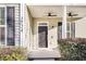 Front entrance with black door, white columns, and ceiling fan at 1724 Bee Balm Rd, Johns Island, SC 29455