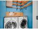 Laundry room with washer, dryer, and built-in shelves at 1724 Bee Balm Rd, Johns Island, SC 29455