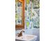 Charming bathroom with lemon tree wallpaper and a white pedestal sink at 2256 Ion Ave, Sullivans Island, SC 29482