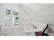 Small bathroom with white pedestal sink and window with shutters at 2256 Ion Ave, Sullivans Island, SC 29482