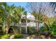 Two-story home with a wrap-around porch and lush landscaping at 2256 Ion Ave, Sullivans Island, SC 29482