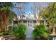 Charming two-story home with a wrap-around porch and lush landscaping at 2256 Ion Ave, Sullivans Island, SC 29482