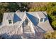 Aerial view of a house with a metal roof, dormer windows, and a rooftop deck at 2256 Ion Ave, Sullivans Island, SC 29482
