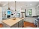 Spacious kitchen with island, stainless steel appliances, and hardwood floors at 2256 Ion Ave, Sullivans Island, SC 29482