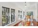 Sun-drenched sunroom with hardwood floors and multiple windows at 2256 Ion Ave, Sullivans Island, SC 29482