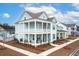 Two-story light teal house with white accents, front porch, and landscaped yard at 229 Symphony Ave, Summerville, SC 29486