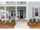Front entrance with black door, white planters, and brick steps at 229 Symphony Ave, Summerville, SC 29486