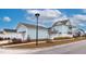 Detached light teal garage with white door, and landscaped yard at 229 Symphony Ave, Summerville, SC 29486