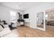 Bright home office features built-in shelving, wood floors, and a view into the dining area at 229 Symphony Ave, Summerville, SC 29486