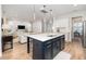 Modern kitchen with a navy island, white cabinets, and quartz countertops at 229 Symphony Ave, Summerville, SC 29486