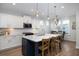 Bright kitchen with white cabinets, stainless steel appliances, and a large island at 229 Symphony Ave, Summerville, SC 29486