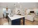 Kitchen features a large island with seating, white cabinets, and stainless steel appliances at 229 Symphony Ave, Summerville, SC 29486