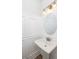 Elegant powder room with pedestal sink and round mirror at 229 Symphony Ave, Summerville, SC 29486