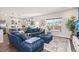 Living room with sectional sofa, kitchen view, and wood floors at 234 Parkwood Vista Way, Summerville, SC 29486