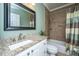 Updated bathroom with granite countertop, tiled shower, and white vanity at 2426 Tuscany Dr, North Charleston, SC 29406