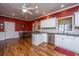 Kitchen with red walls, white cabinets, and island at 2426 Tuscany Dr, North Charleston, SC 29406