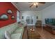 Living room with hardwood floors, green sofa, and access to patio at 2426 Tuscany Dr, North Charleston, SC 29406
