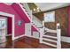 Grand staircase with white railings and hardwood floors at 30 Gibbes St, Charleston, SC 29401