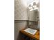 Stylish powder room with wood vanity and patterned wallpaper at 3168 Treadwell St, Mount Pleasant, SC 29466