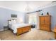 Charming bedroom with light blue walls and wood furniture at 3168 Treadwell St, Mount Pleasant, SC 29466