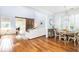 Casual dining area with a rustic wooden table and chairs, near a sunlit living room at 3168 Treadwell St, Mount Pleasant, SC 29466