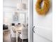 White door with a wheat wreath, offering a glimpse into a dining and living area at 3168 Treadwell St, Mount Pleasant, SC 29466