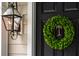 Black front door with a lush green wreath at 3168 Treadwell St, Mount Pleasant, SC 29466