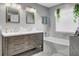 Bathroom with double vanity, marble accents, and a large soaking tub at 320 Harry Ln, Moncks Corner, SC 29461
