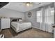 Cozy bedroom with a king-size bed, ceiling fan, and neutral color palette at 320 Harry Ln, Moncks Corner, SC 29461