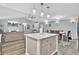 Large kitchen island with white cabinets and granite countertop, open to living area at 320 Harry Ln, Moncks Corner, SC 29461