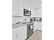 Modern kitchen with white cabinets, granite countertops and stainless steel appliances at 320 Harry Ln, Moncks Corner, SC 29461