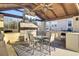 Relaxing outdoor kitchen and dining area with fireplace and TV at 320 Harry Ln, Moncks Corner, SC 29461