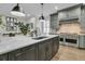 Modern kitchen with gray cabinets, marble countertops, and stainless steel appliances at 3337 Ethan St, Mount Pleasant, SC 29466