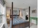 Bedroom with four-poster bed, green accent table, and access to another room at 3809 Tupelo Branch Row, Mount Pleasant, SC 29429