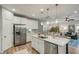 Open kitchen features island with seating, stainless steel appliances, and white cabinets at 3809 Tupelo Branch Row, Mount Pleasant, SC 29429