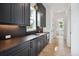 Modern butler's pantry with dark cabinetry and quartz countertops at 3908 Delinger Dr, Mount Pleasant, SC 29466