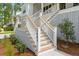 Elevated front porch with white railings and wooden steps at 3908 Delinger Dr, Mount Pleasant, SC 29466