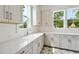 Bright laundry room with white shaker cabinets and quartz countertops at 3908 Delinger Dr, Mount Pleasant, SC 29466