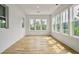 Bright sunroom with hardwood floors and wall-to-wall windows at 3908 Delinger Dr, Mount Pleasant, SC 29466