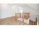 Bright upper hallway with hardwood floors and wooden railings at 3908 Delinger Dr, Mount Pleasant, SC 29466