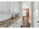 Butlers pantry with white cabinets and herringbone backsplash at 3913 Maidstone Dr, Mount Pleasant, SC 29466
