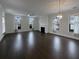 Open living room with dark hardwood floors and a fireplace at 4140 Home Town Ln, Ravenel, SC 29470