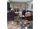 Messy living room with maroon couches and cluttered floor at 4328 Helene Dr, North Charleston, SC 29418