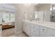 Double vanity bathroom with a large mirror and view into bedroom at 444 Parish Farms Dr, Summerville, SC 29486