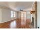 Living room with hardwood floors, fireplace, and ceiling fan at 4960 Lambs Rd, North Charleston, SC 29418