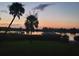 Stunning sunset over calm water, palm trees, and boats at 4960 Lambs Rd, North Charleston, SC 29418