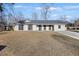 Ranch style home with gray siding, gray roof, and a long driveway at 504 Temple Rd, Ladson, SC 29456